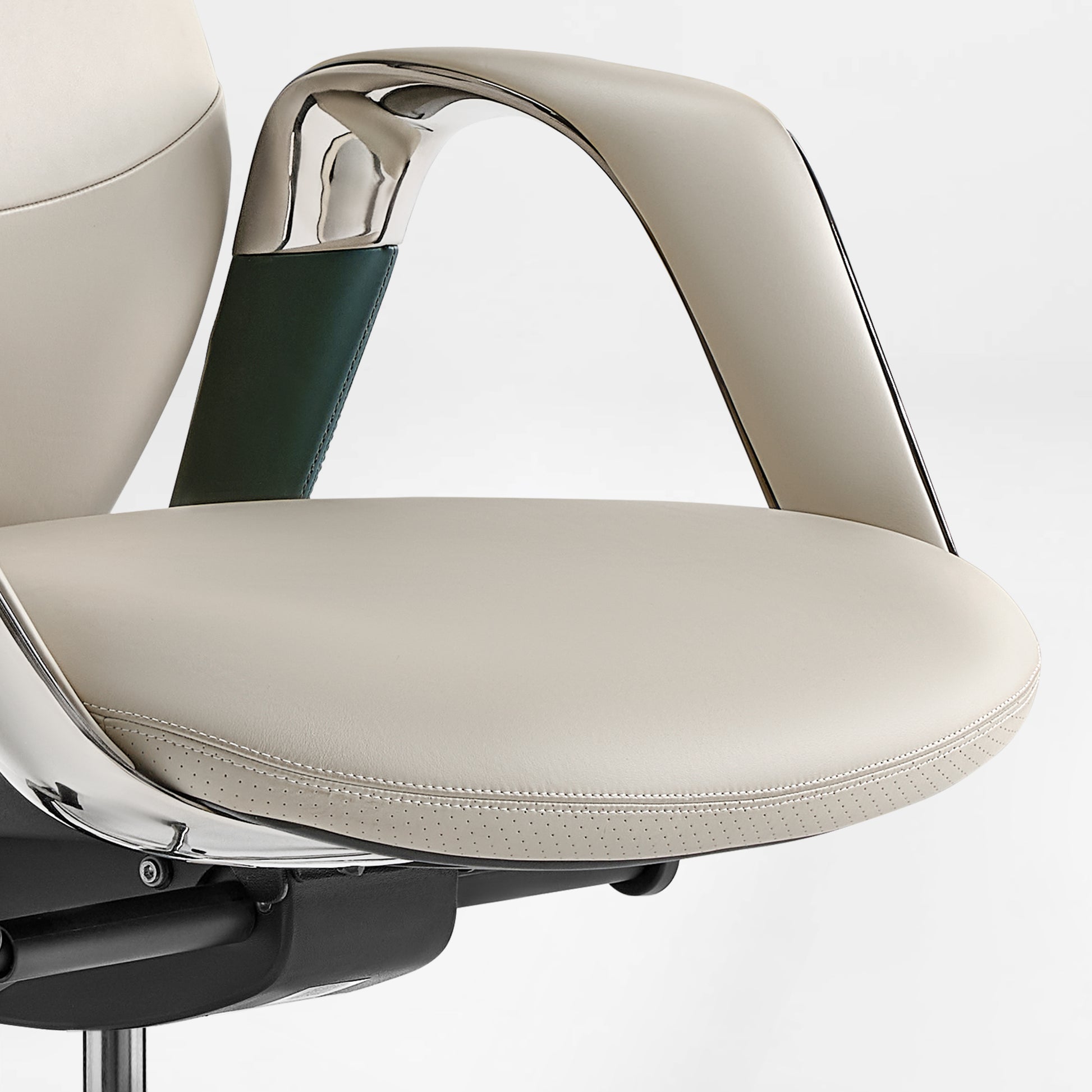 Eureka Ergonomic Serene chair: cream perforated Napa leather seat, contrast stitching, chrome armrest with dark green leather accent.