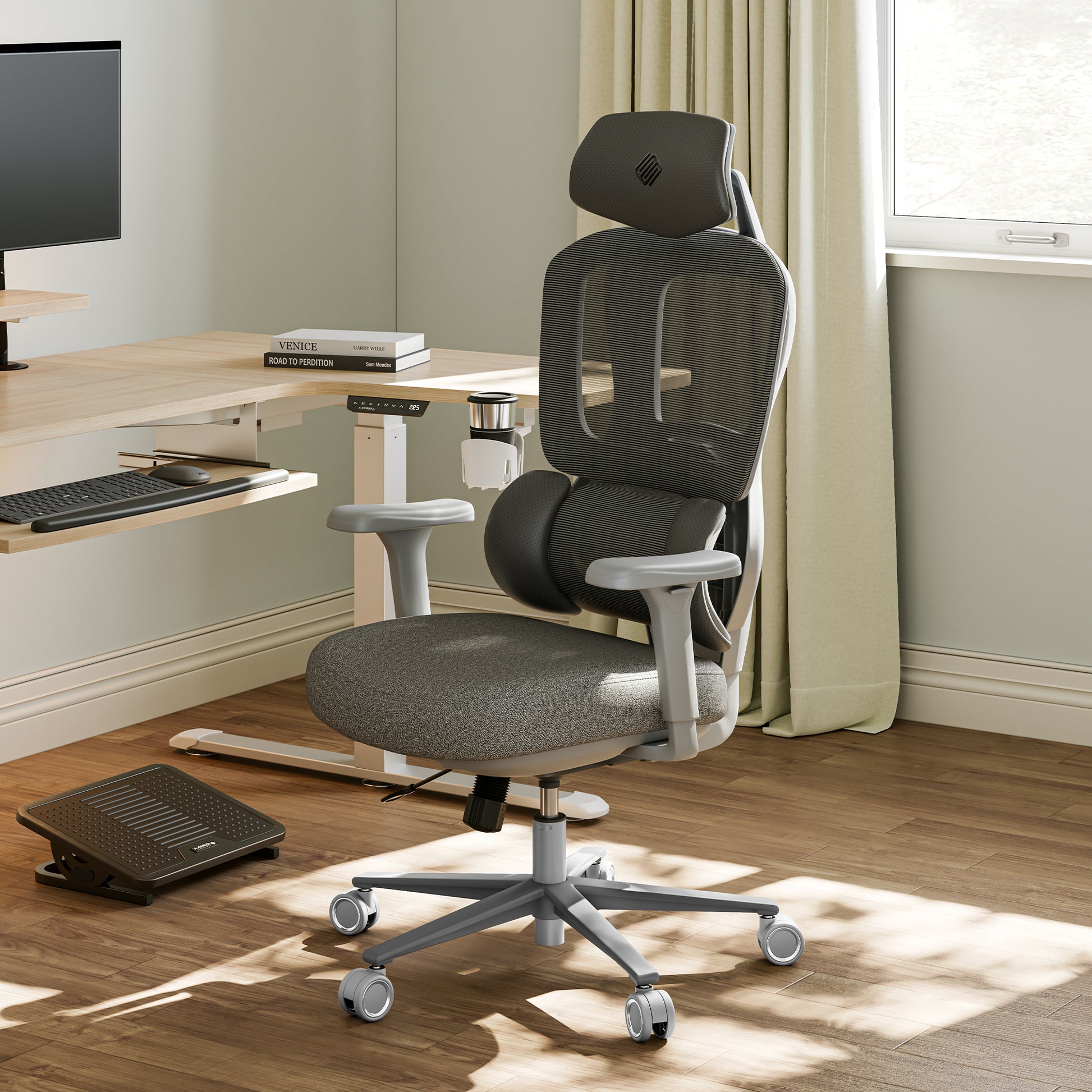 Gray office chair in a home office setting with a desk and computer monitor.