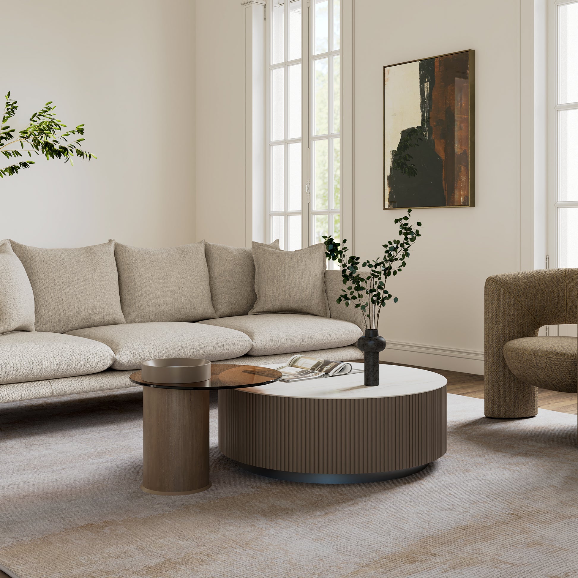 Modern Round Sintered Stone Coffee Table Set in a Living Room, With a Beige Sofa and Armchair.