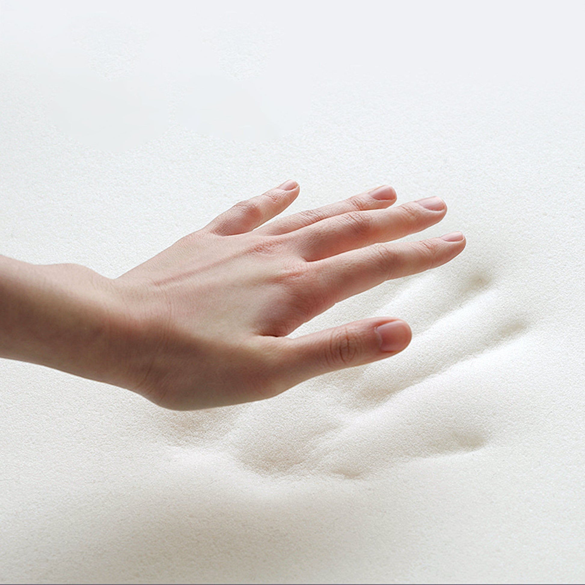 Hand Pressing Into Soft White Eco-Fabric of the Modern Lounge Chair, Showcasing Comfort.