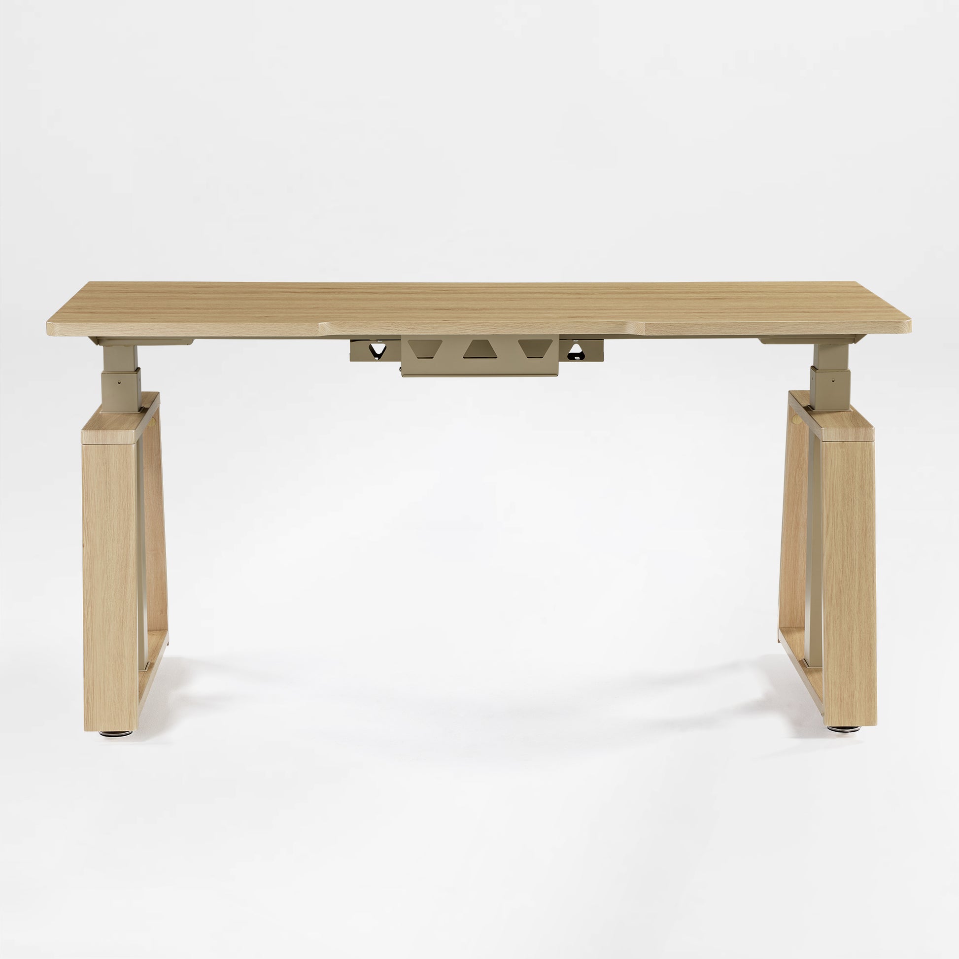 Eureka Ergonomic Ark Lite standing desk with light woodgrain MDF top, beige trapezoidal legs, and integrated cable management tray.