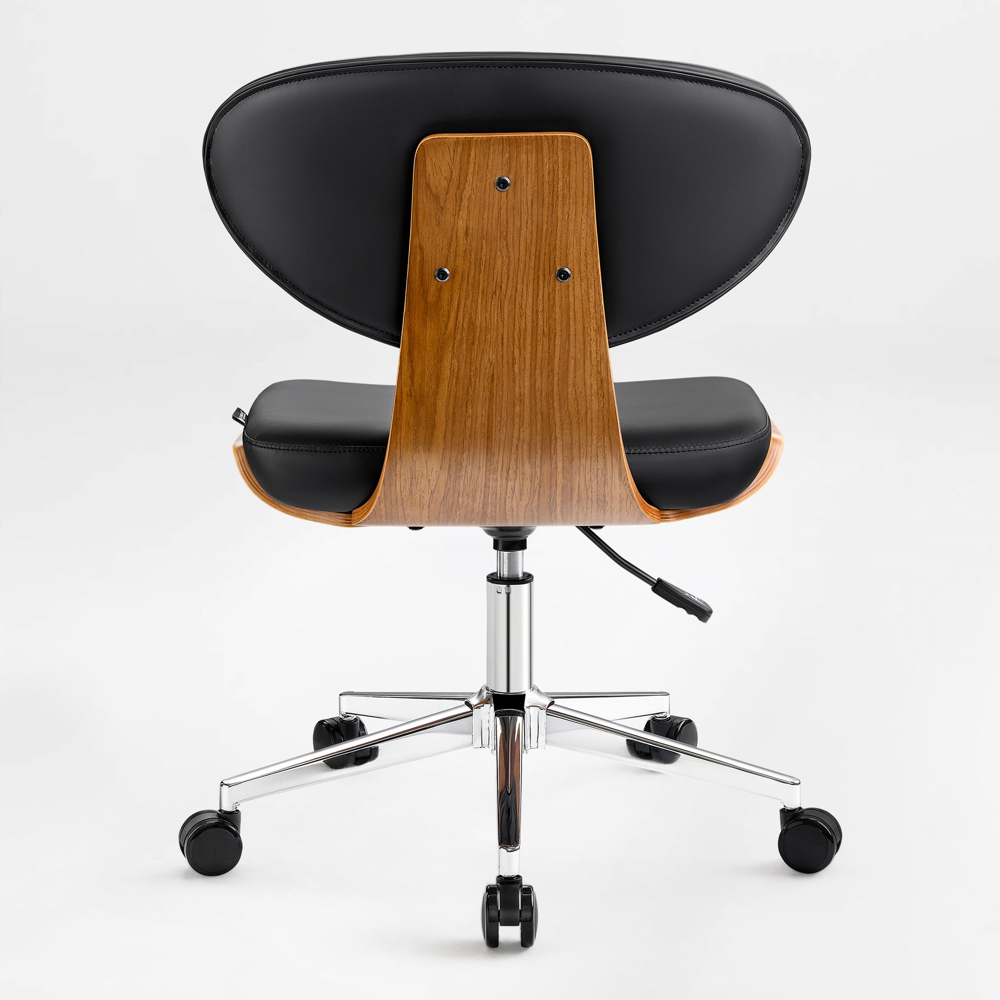 Eureka Ergonomic Matt black faux leather office chair with curved walnut veneer shell and chrome base on casters, back view.