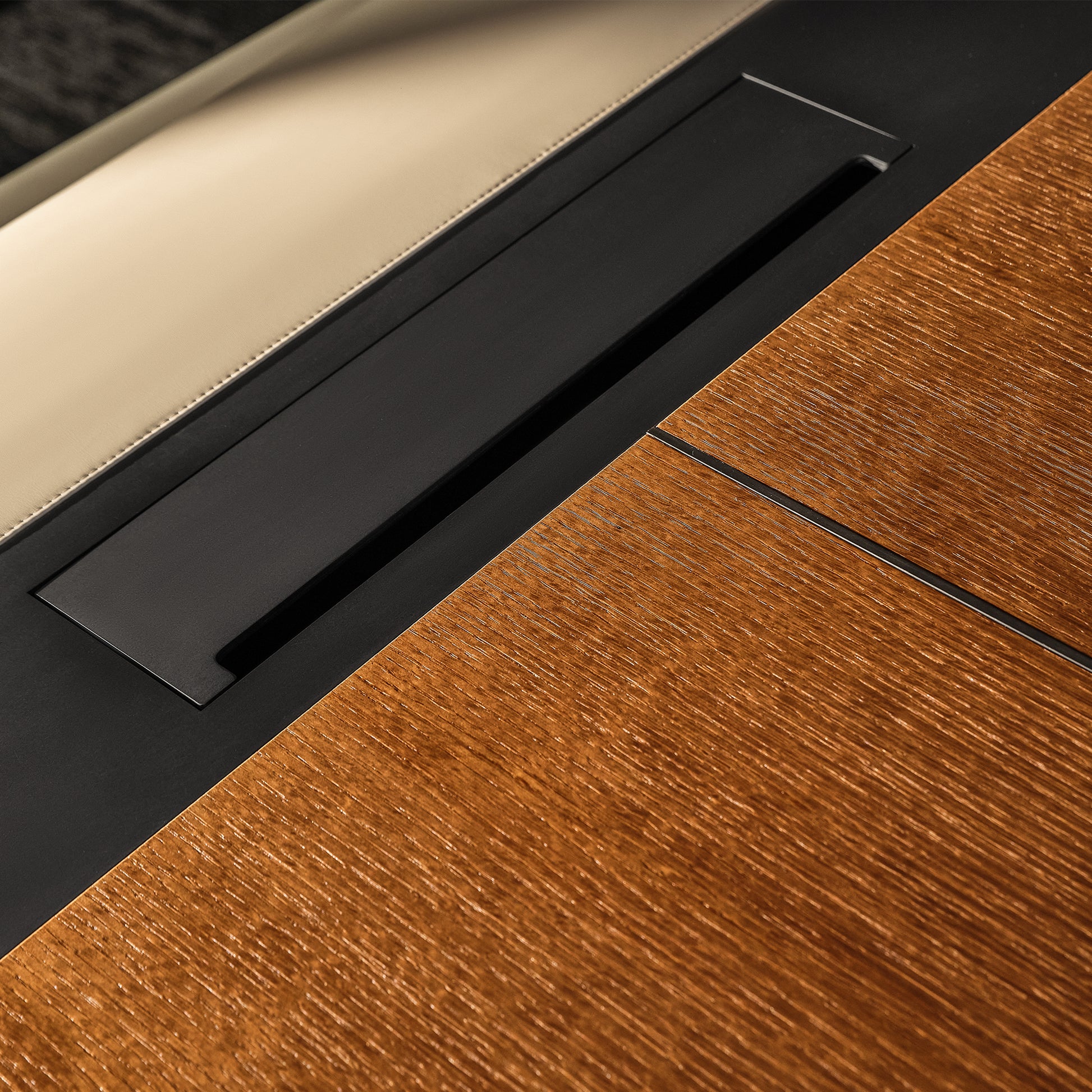 Eureka Ergonomic Zen Lunar executive desk close-up: rich wood grain, beige leatherette inlay, black metal accents. Materials detail.
