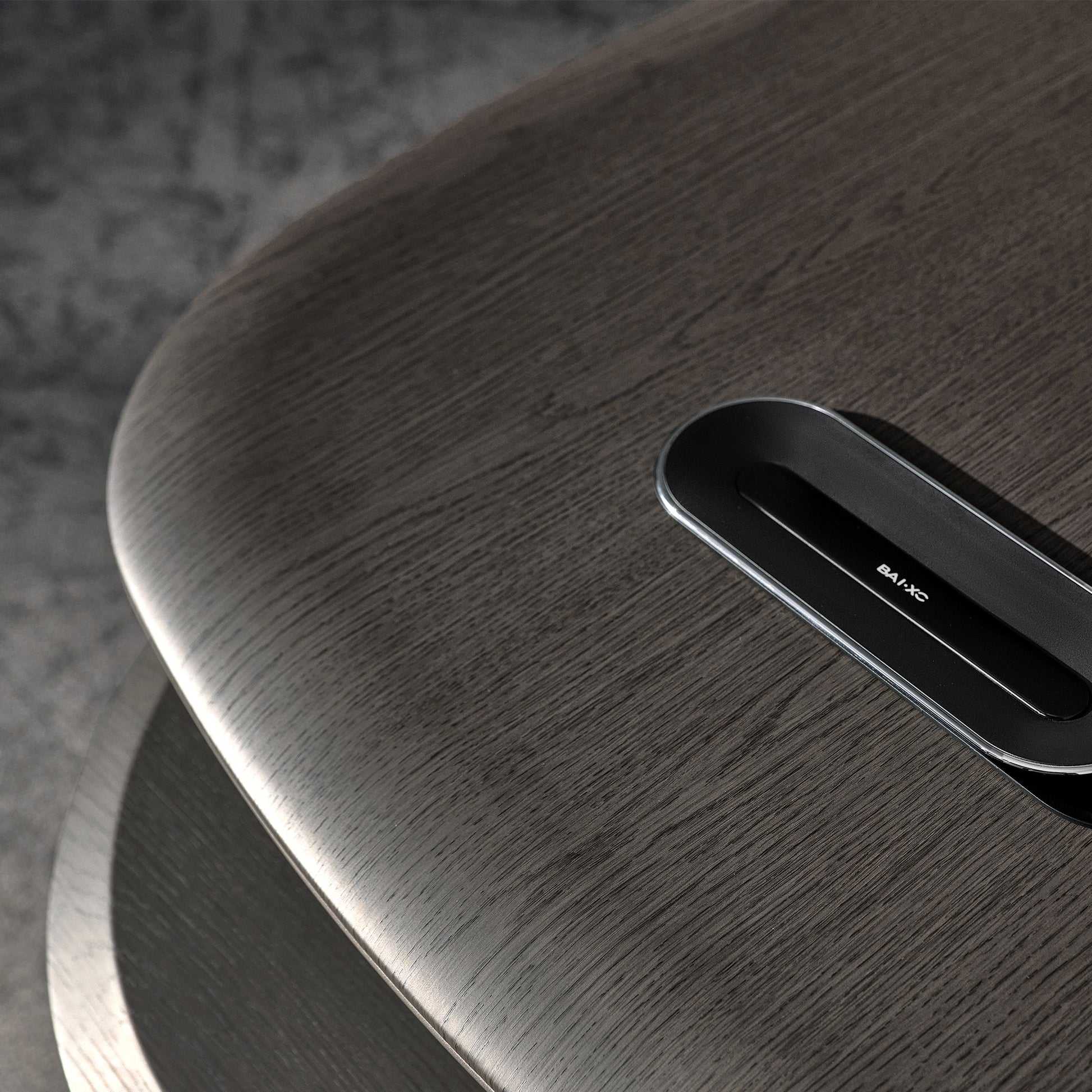 Eureka Ergonomic Zen Orion executive desk surface close-up: dark wood grain with integrated BAIXC tech hub.