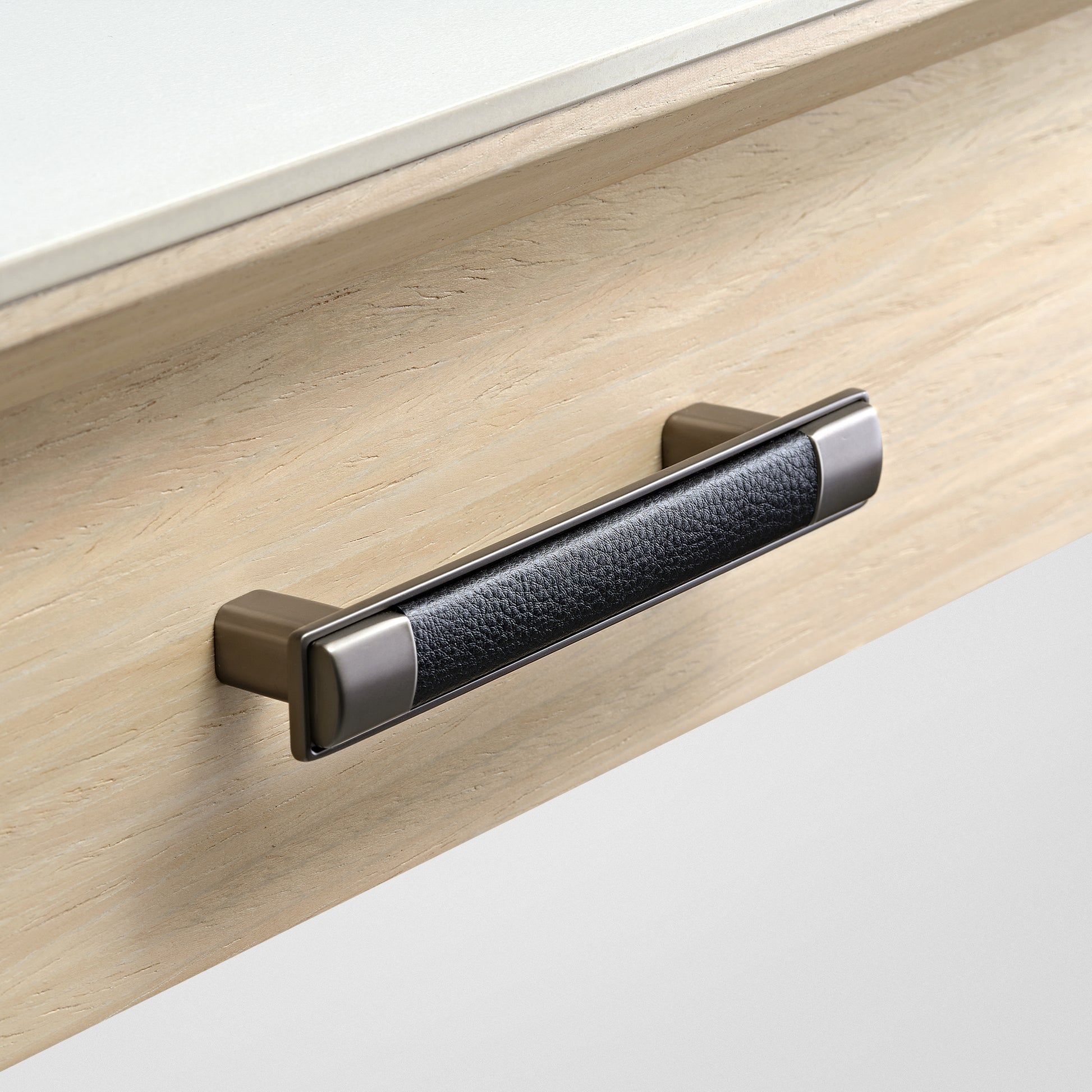Eureka Ergonomic Ark Pro Desk Drawer Handle Detail. Black Leather Grip and Wood Grain Accent for Luxury Desk.