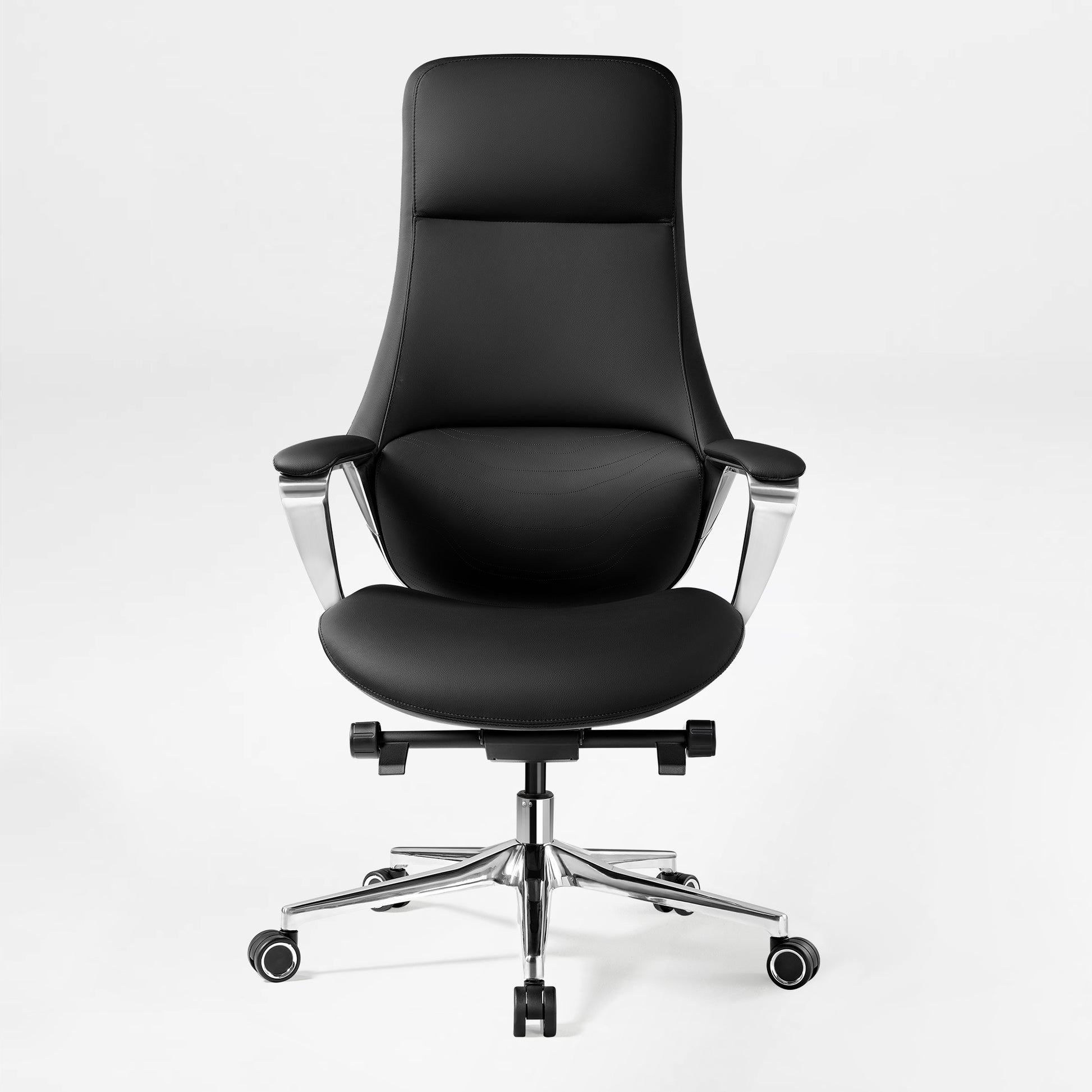 Eureka Ergonomic Nox black genuine leather executive chair with high back, plush seat, wave stitching, and polished chrome armrests and base.