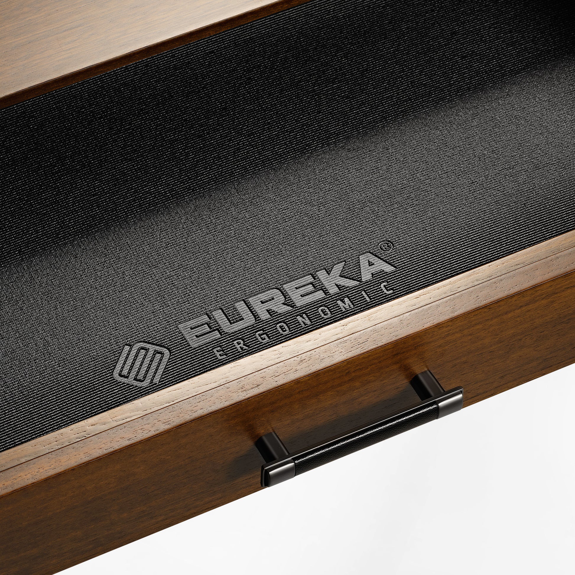 Eureka Ergonomic Ark Pro L-Shaped Desk Drawer Detail: Walnut Wood, Black Leather Handle, and Brand Logo.