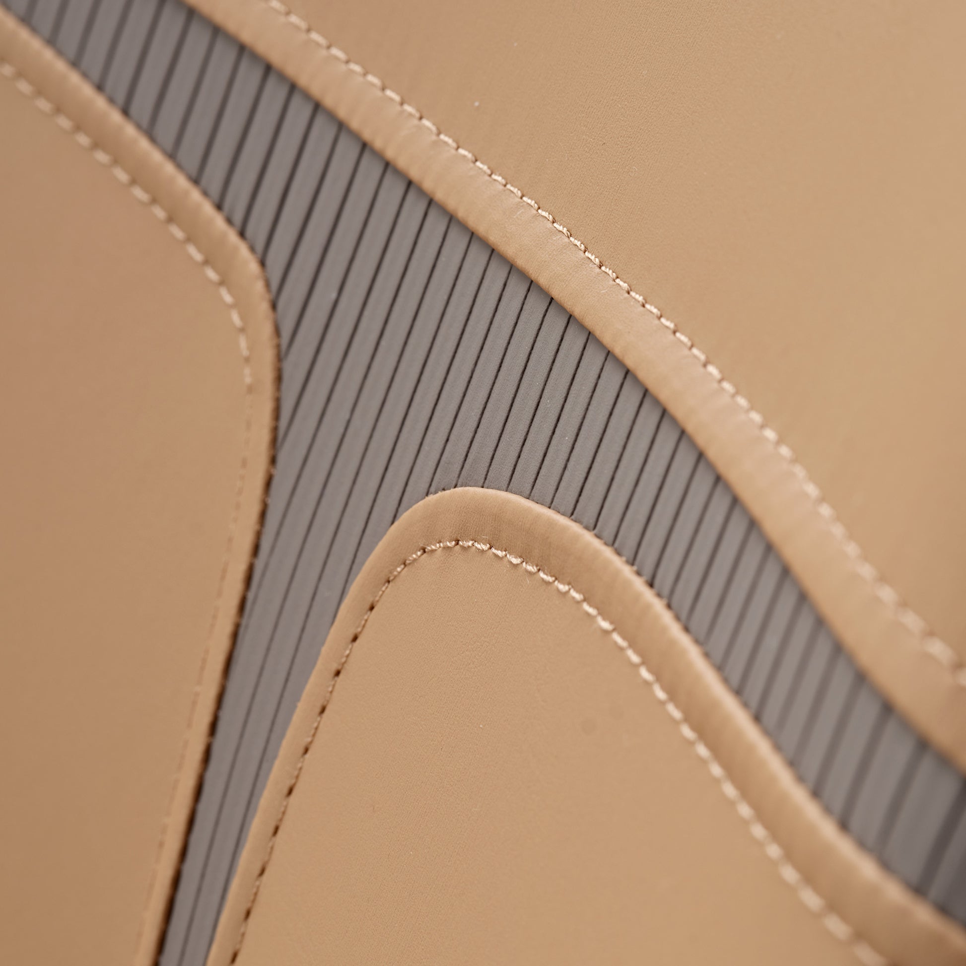 Turmeric Leather Couture Dining Chair Detail, Showing Stitching and Gray Accents.