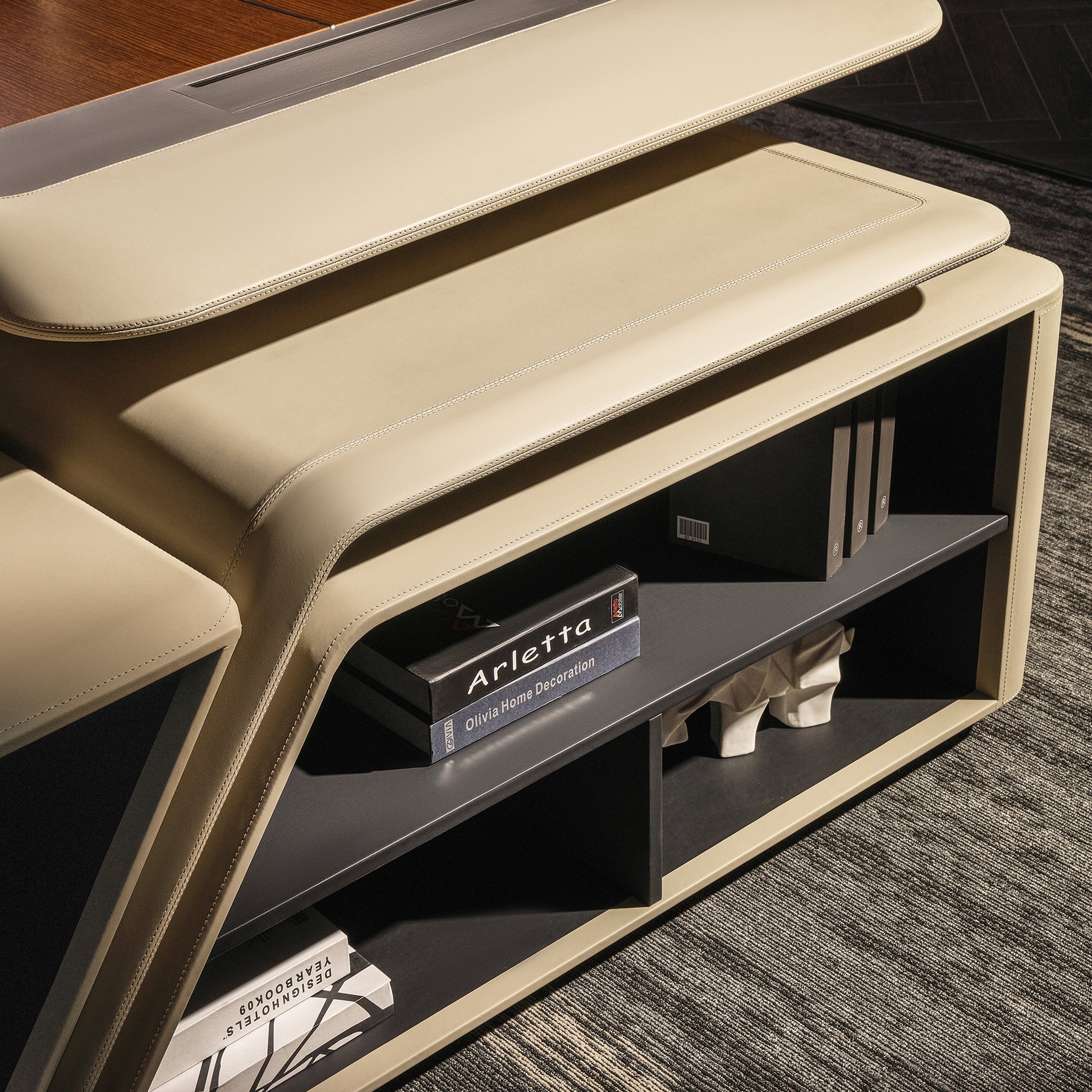 Eureka Ergonomic Zen Lunar executive desk close-up with beige leatherette and dark wood top, featuring integrated bookcase with books.