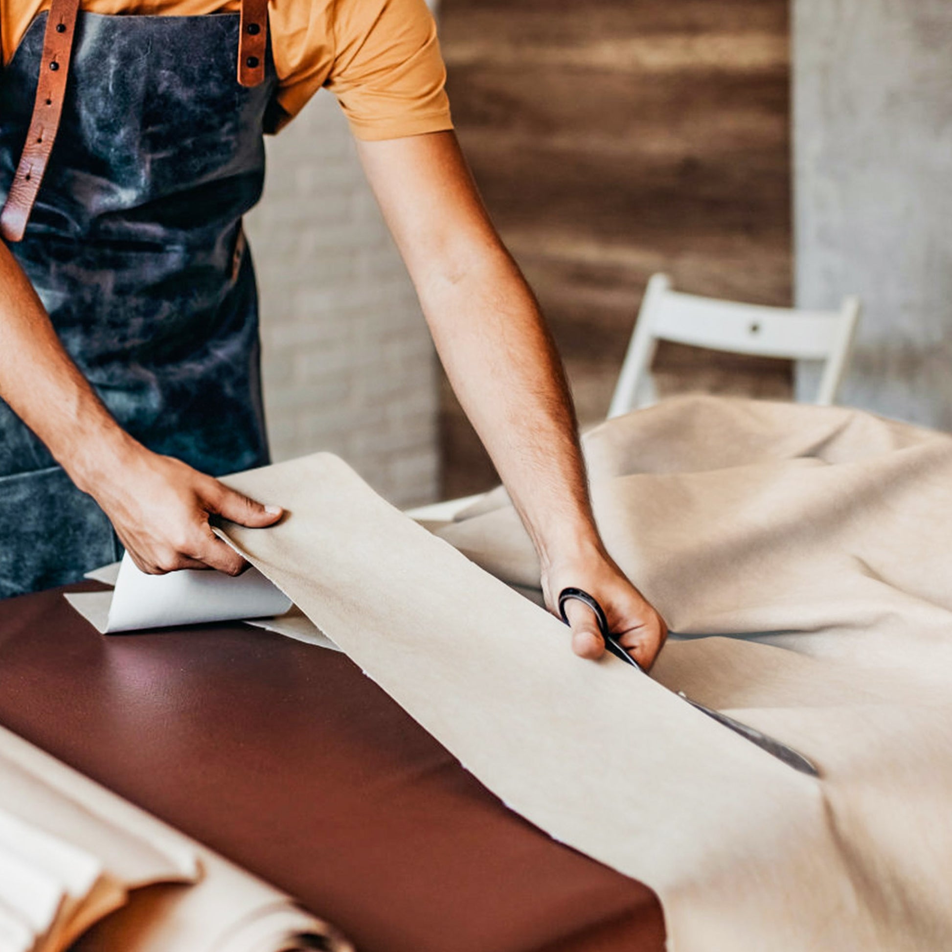 Craftsman Cutting Napa Leather for Serene Executive Office Chair, Highlighting the Materials and Craftsmanship.