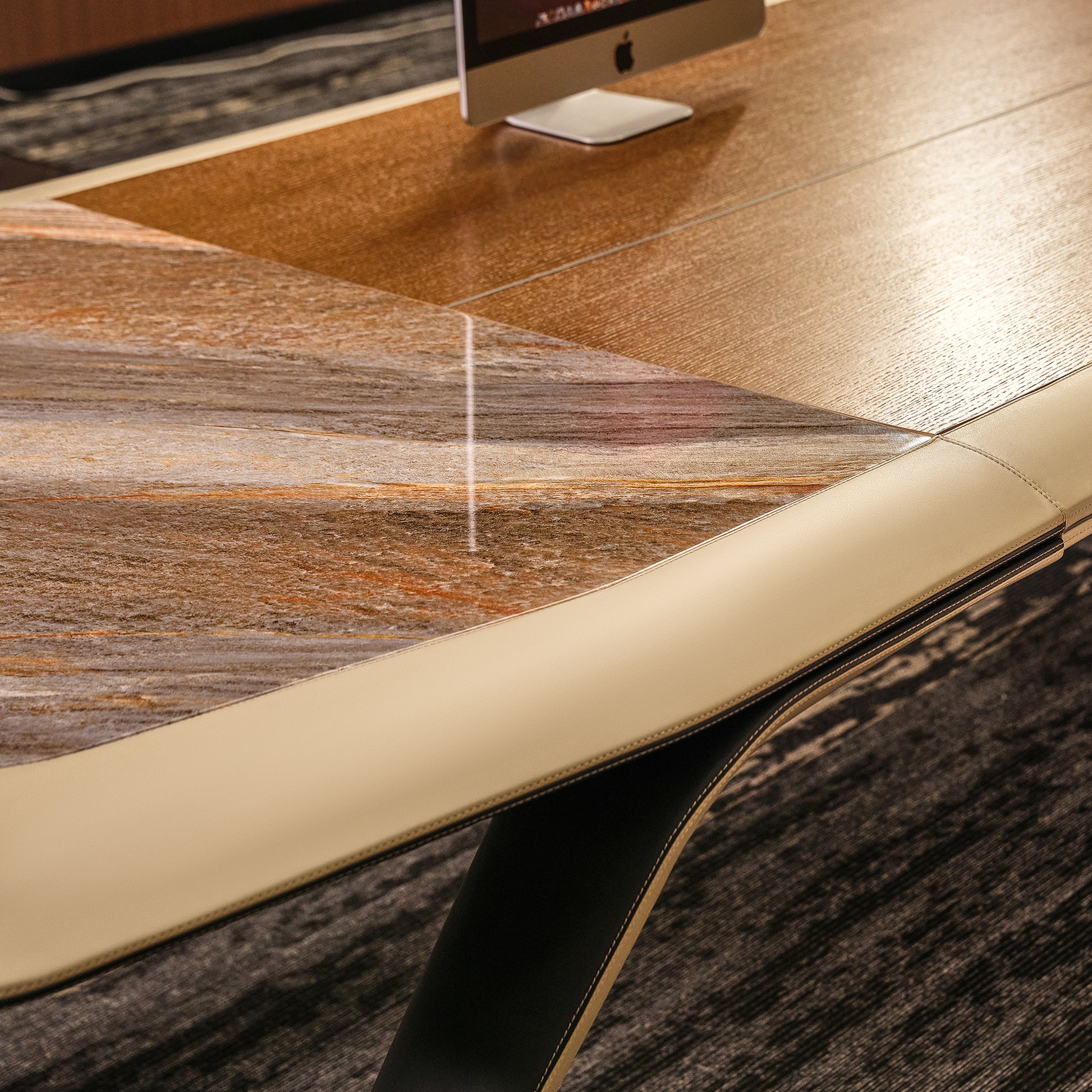 Eureka Ergonomic Zen Lunar executive desk close-up: warm wood grain, marble inlay, beige leatherette border. Modern design detail.