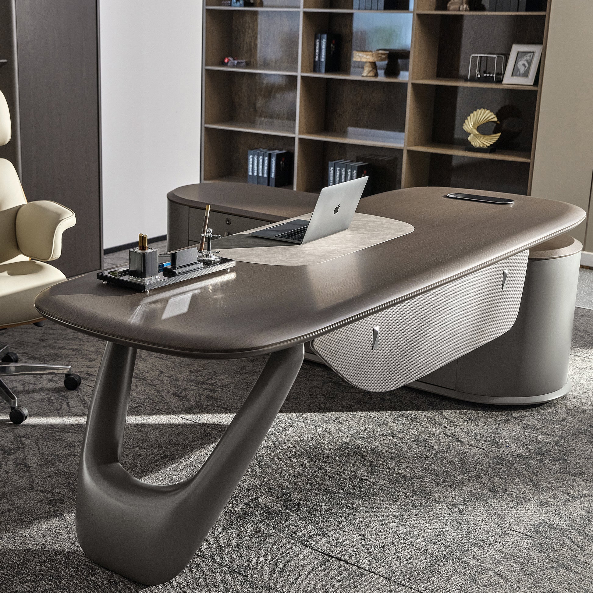 Eureka Ergonomic Zen Orion executive desk: dark wood elliptical top, curved metal legs, textured cabinet, laptop. Matching bookcase.