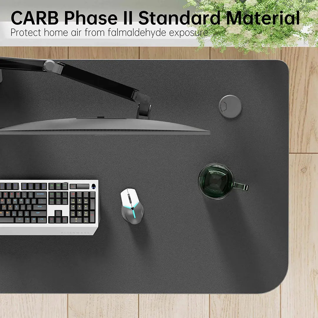 Eureka Ergonomic L-Shaped Desk With Carb Phase Ii Material - Black Desk Setup With Monitor, Keyboard, Mouse, and Water Glass.