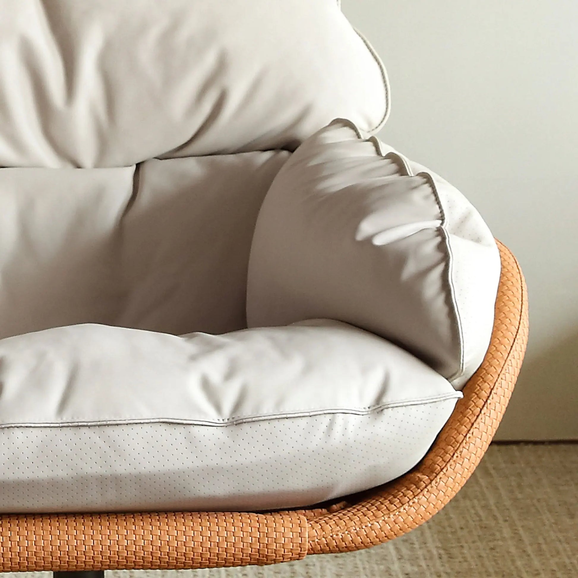 Cream Todd Swivel Armchair With High Back, Featuring Ergonomic Design and Orange Woven Side Detail.