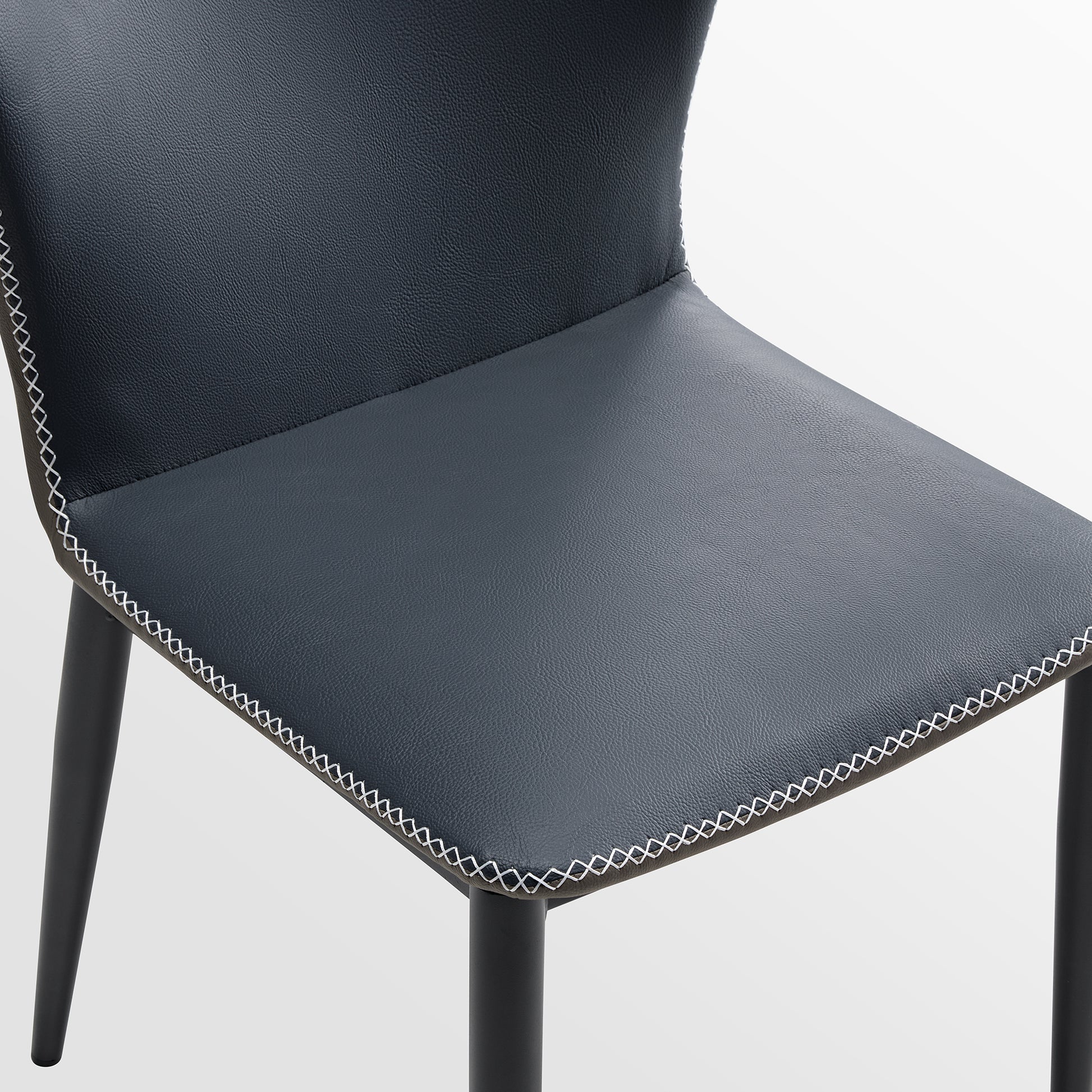 Elysian Blue Dining Chair Detail: Dark Blue Pu Leather With White Stitching and Black Metal Legs.