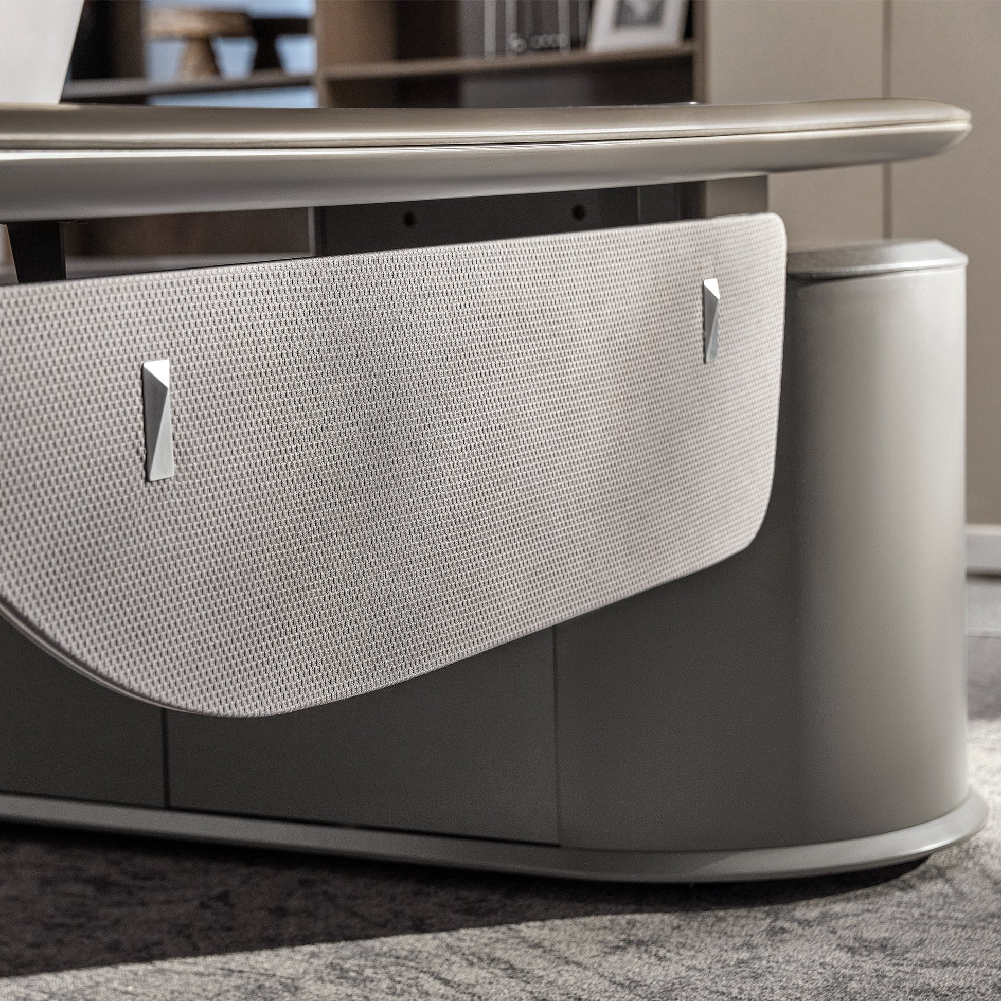 Eureka Ergonomic Zen Orion executive desk close-up: light gray textured panel with geometric silver accents and curved matte gray base.
