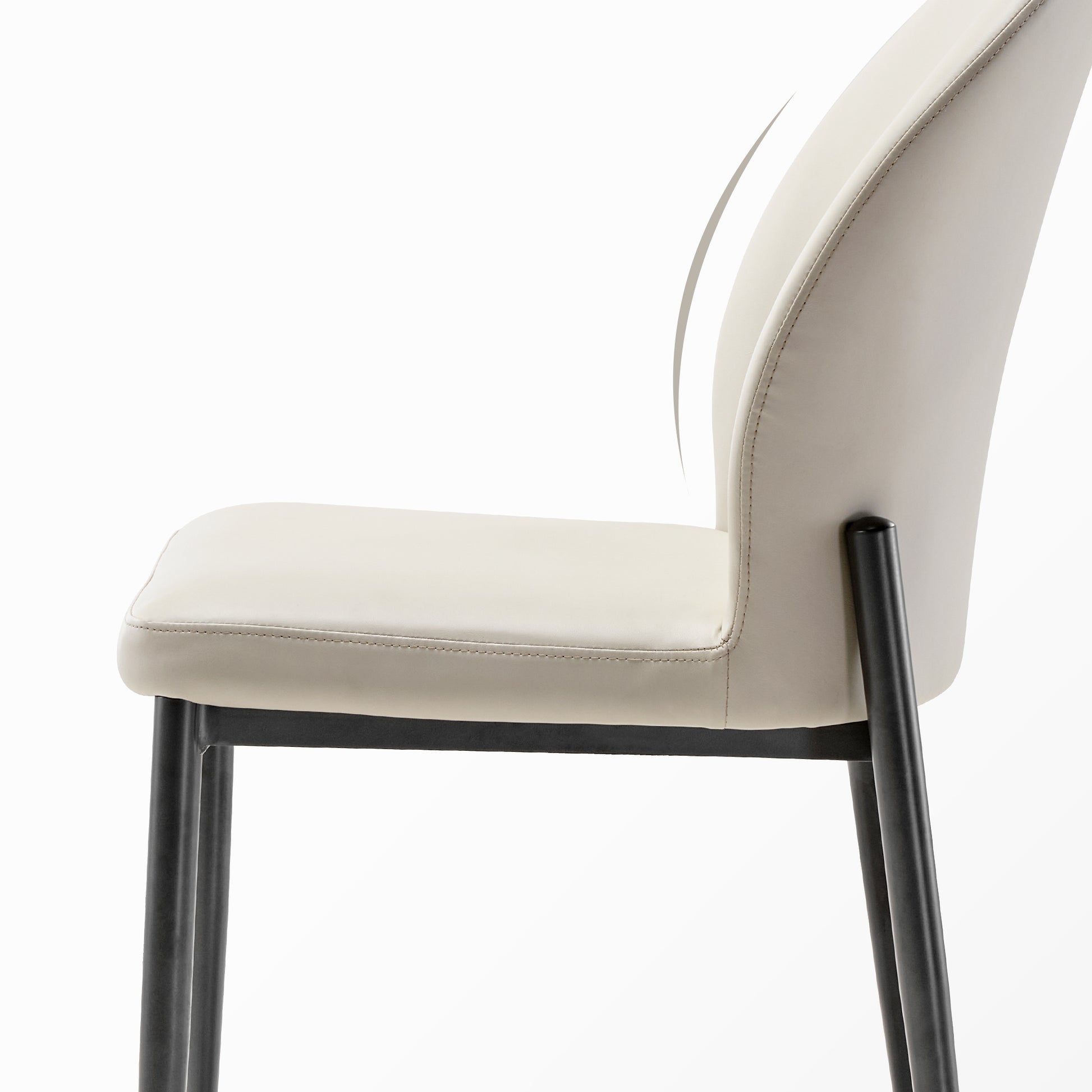 Off-White Leather Dining Chair Profile View With Black Metal Legs. Minimalist Modern Design.