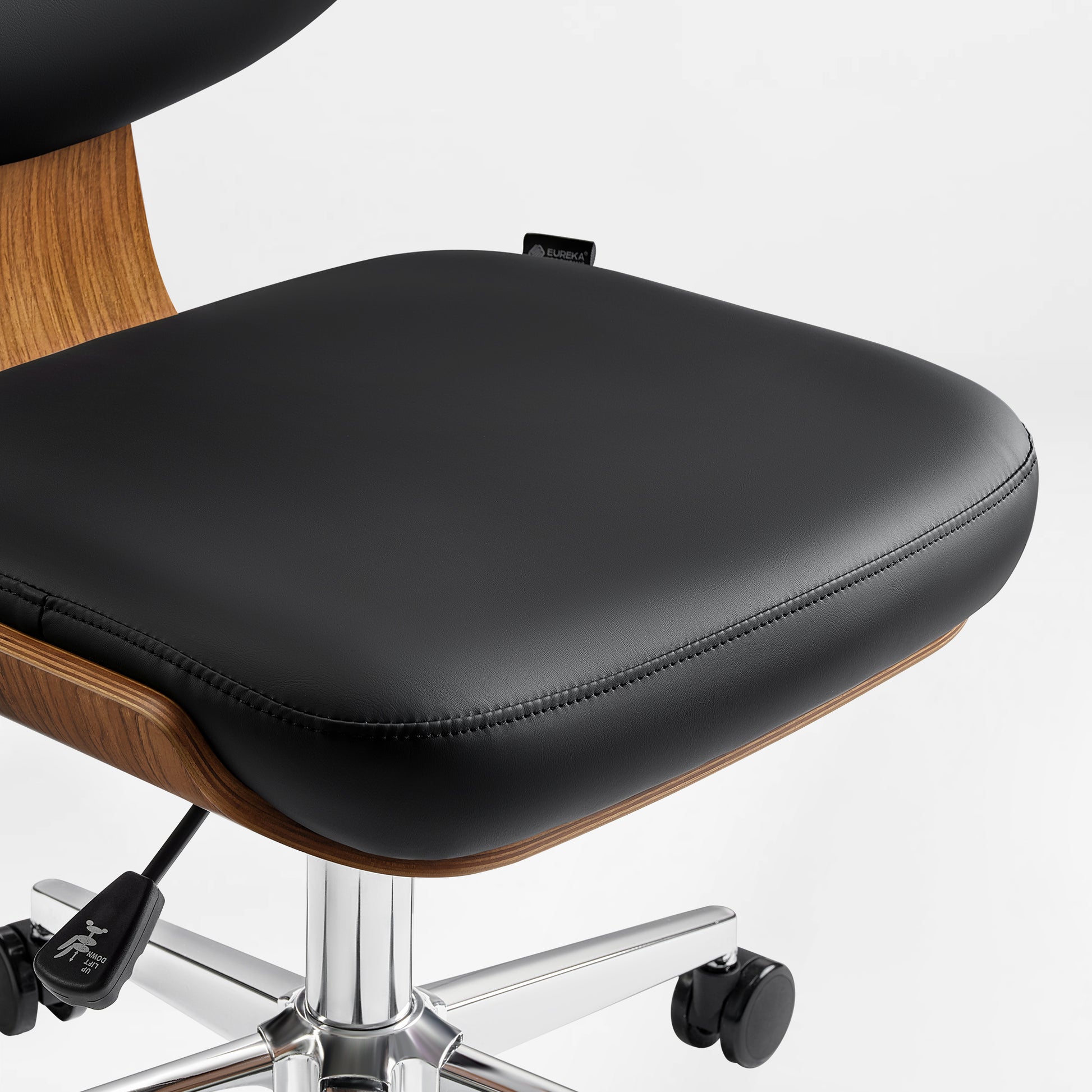 Eureka Ergonomic Ergonomic Matt faux leather office chair with stitching, walnut shell, chrome base, casters, and height lever.