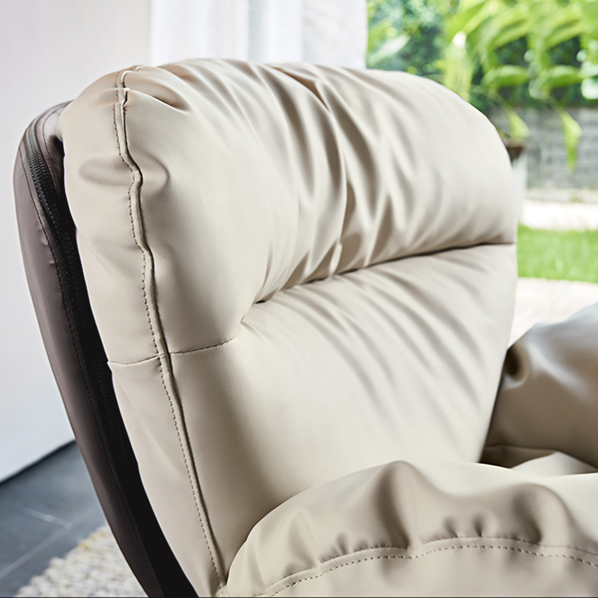 Alexia Comfy Soft Swivel Lounge Chair Detail, Showing Cream Vegan Leather and Stitching, Part of the Ergonomic Design.