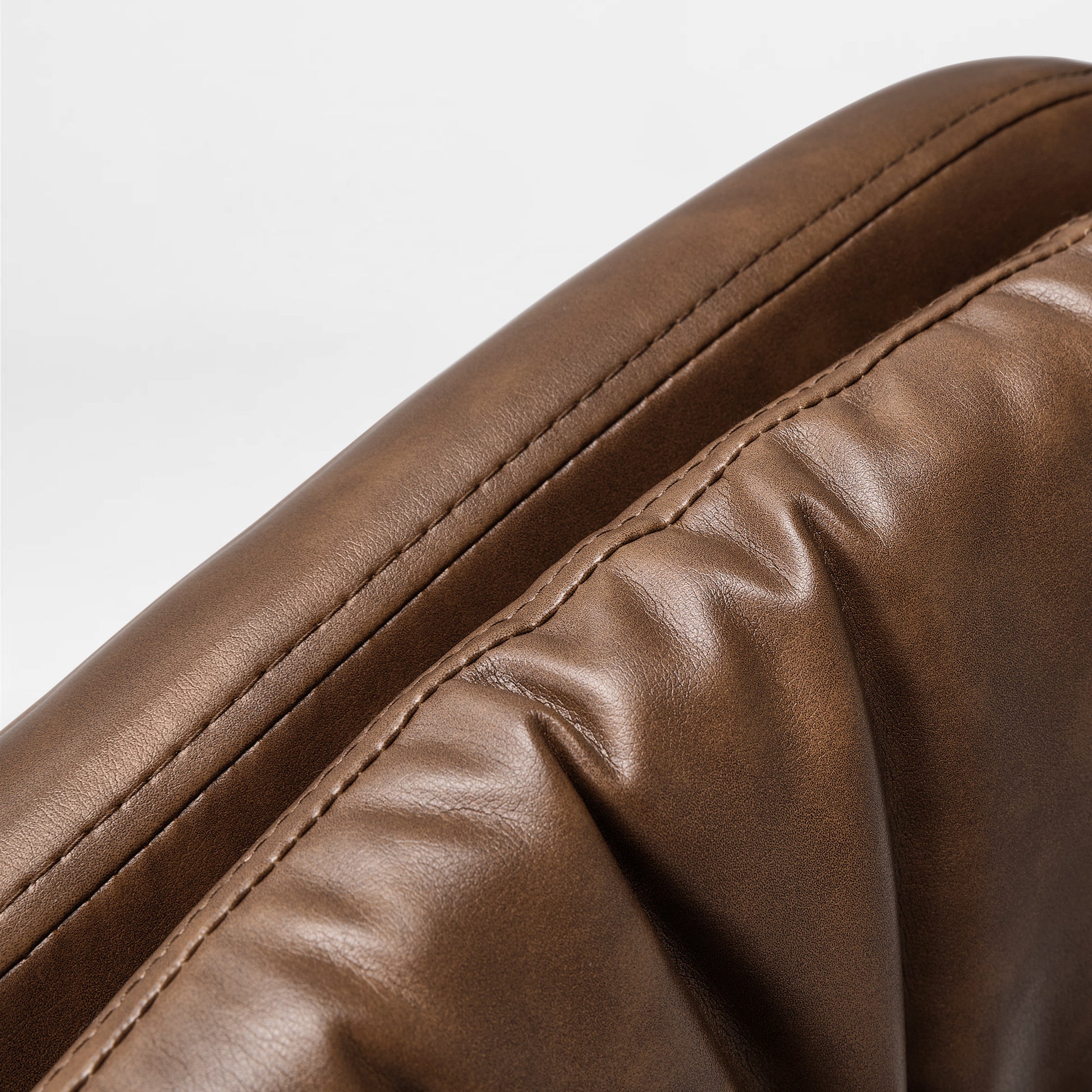 Eureka Ergonomic Brown PU leather texture on Regal home office chair, showing stitching and soft cushioning detail.
