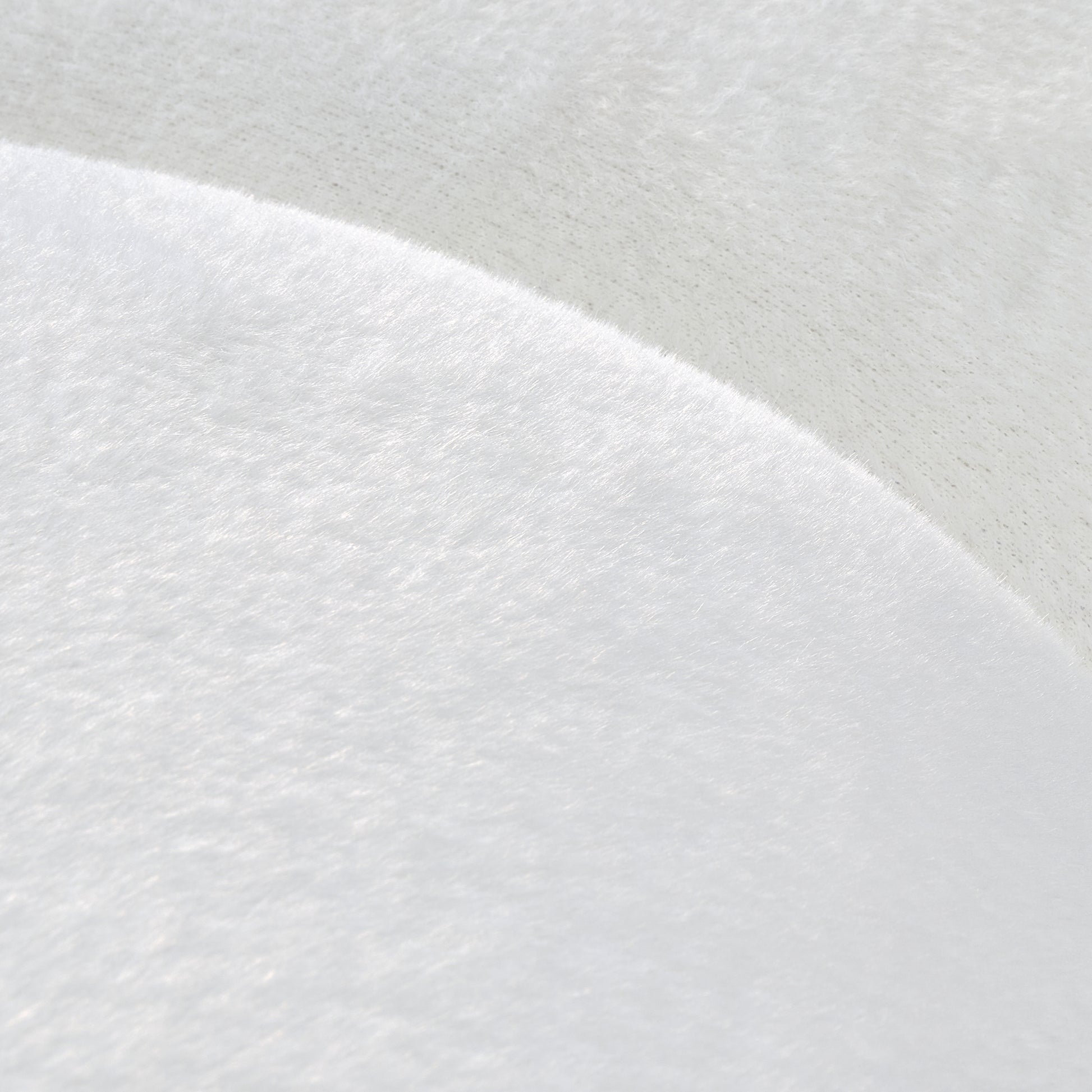 Adele Modern Curved Sofa Detail, Soft White Plush Fabric, Comfortable Texture, and Modern Design for the Living Room.