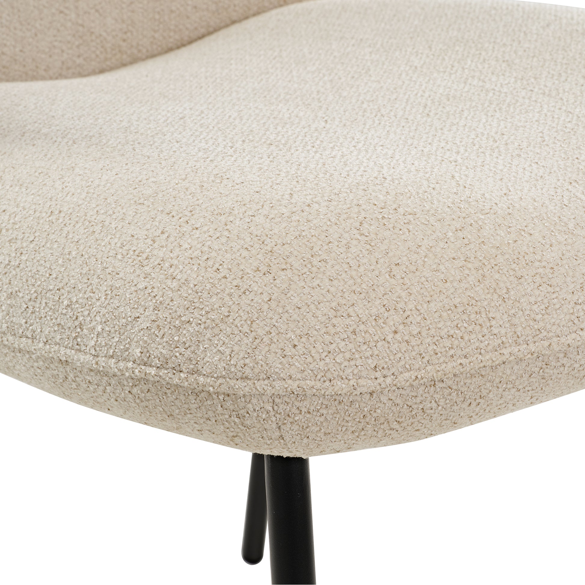 Off-White Upholstered Dining Chair Detail. Modern Dining Chair With Textured Fabric and Black Legs.