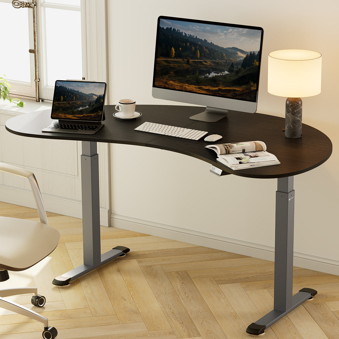 Eureka Ergonomic Cashew Shape Standing Desk in Dark Woodgrain With Monitor and Laptop. Modern Ergonomic Home Office Setup.