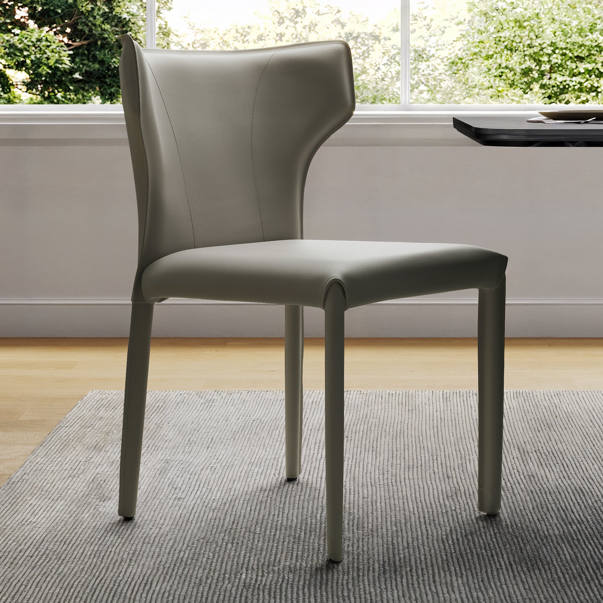 Gray Leather Dining Chair With Whale-Tail Backrest, Perfect for Modern Dining and Living Spaces.
