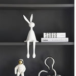 White Rabbit Ornament HD-06, With Other Decorative Items On a Gray Shelf, Minimalist Home Decor.