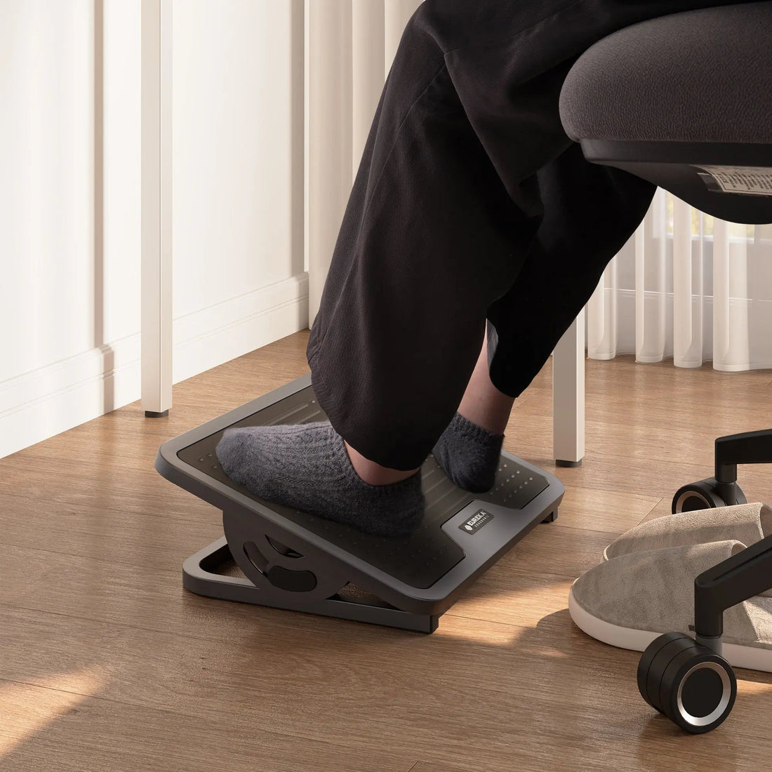 Under-desk foot support for an office chair that sits high enough for the keyboard and monitor.