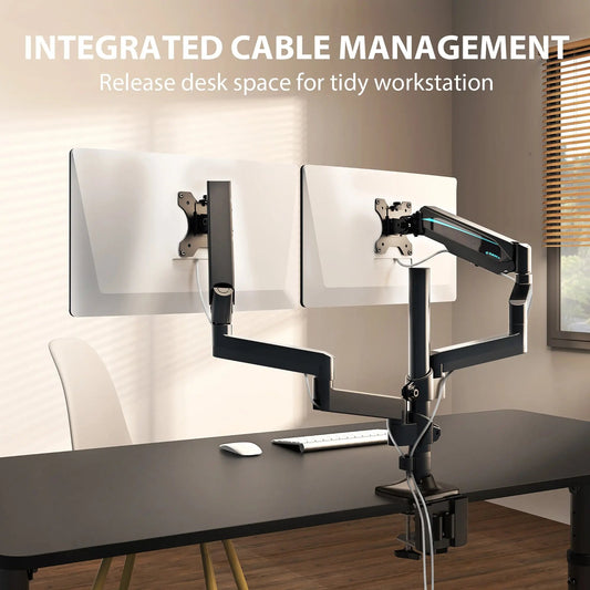 A dual-monitor desk setup keeps the main screen centered while the monitor arm preserves active work surface.