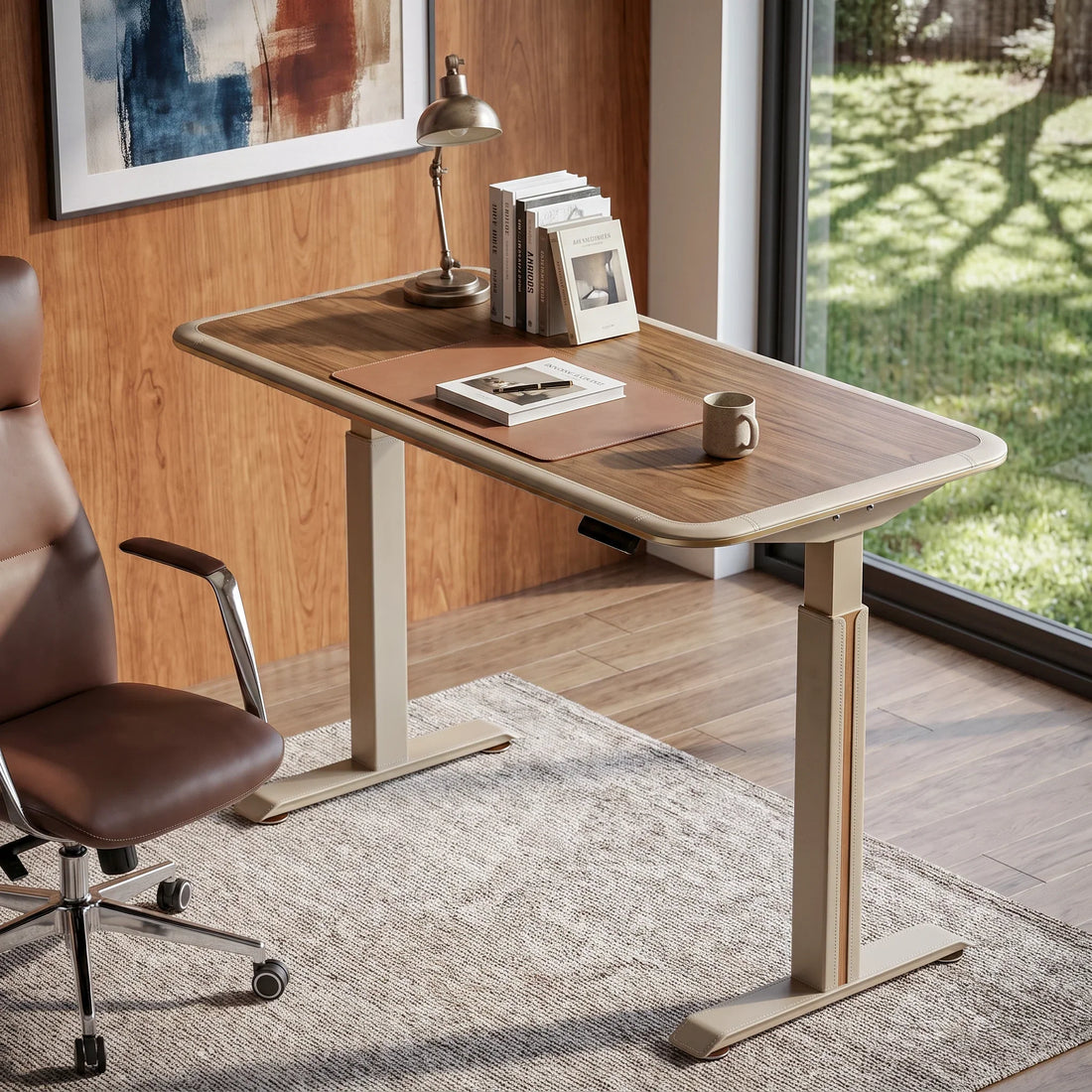 Norwood electric standing desk and brown leather chair in a walnut-paneled home office.