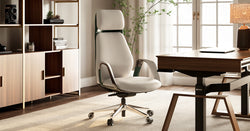 A white ergonomic office chair in a modern office setting.
