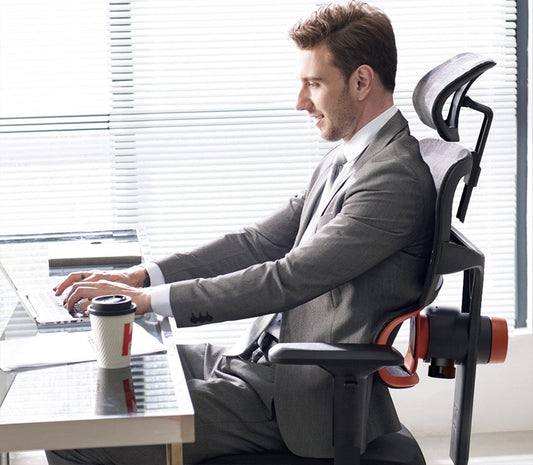 A man sitting in an ergonomic office chair.