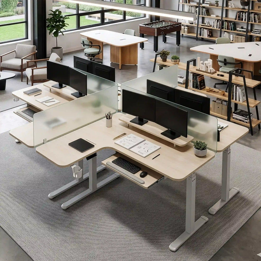 Modern open office with height adjustable desks and privacy screens