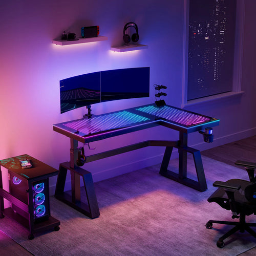 A modern gaming standing desk setup with dual monitors and RGB lighting.