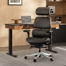 Eureka Ergonomic Black Forma ergonomic PU leather executive office chair with adjustable headrest and aluminum base in a modern home office.