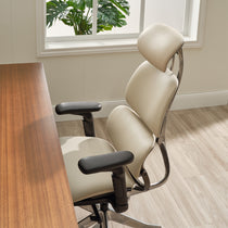 Eureka Ergonomic Light beige Forma ergonomic office chair with black armrests, aluminum frame, and adjustable headrest in a home office.