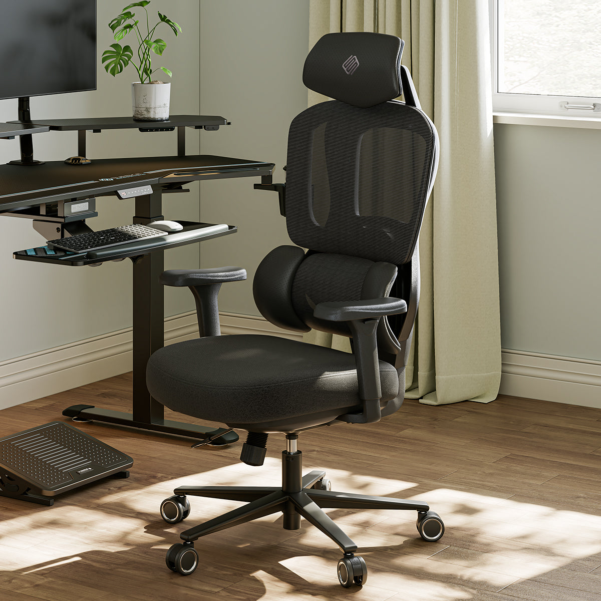 Typhon II Hybrid Ergonomic Gaming Chair in a home office setting with a desk and computer setup, black