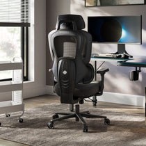 Typhon II Hybrid Ergonomic Gaming Chair in a modern office setting with a computer desk and monitor, black