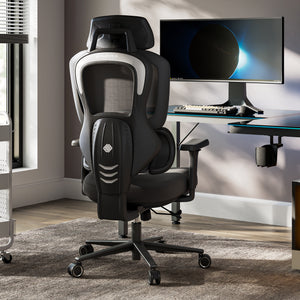 Typhon II Hybrid Ergonomic Gaming Chair in a modern office setting with a computer desk and monitor, black