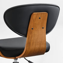 Eureka Ergonomic Matt black faux leather chair with curved walnut veneer shell, showcasing stitching and wood grain detail.