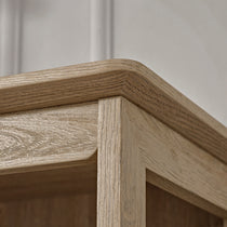 Eureka Ergonomic Ark El Oak Cabinet Corner, Showcasing Wood Grain Detail and Rounded Edge.