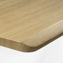 Ark Lite Standing Desk Detail, Light Woodgrain Finish With Rounded Edge, Durable Surface.