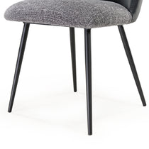 Solace Dining Chair Detail, Featuring Gray Upholstered Seat, Black Leather Back, and Black Metal Legs.