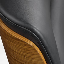Eureka Ergonomic close-up of the black Mathias Mason chair's walnut back and leather upholstery seam
