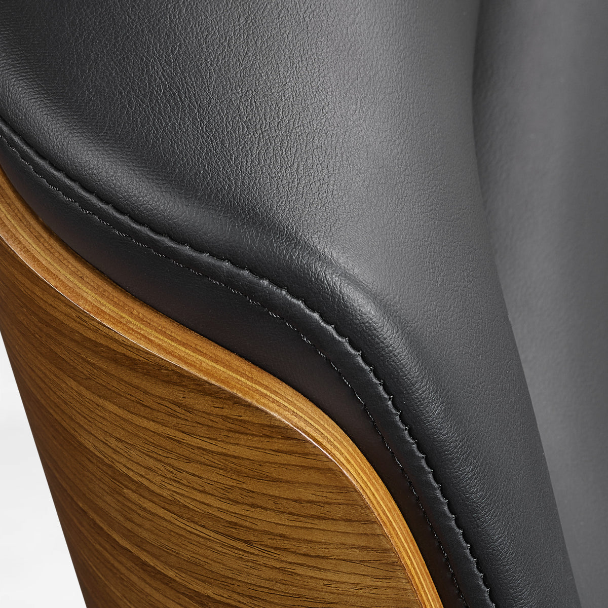 Eureka Ergonomic close-up of the black Mathias Mason chair's walnut back and leather upholstery seam
