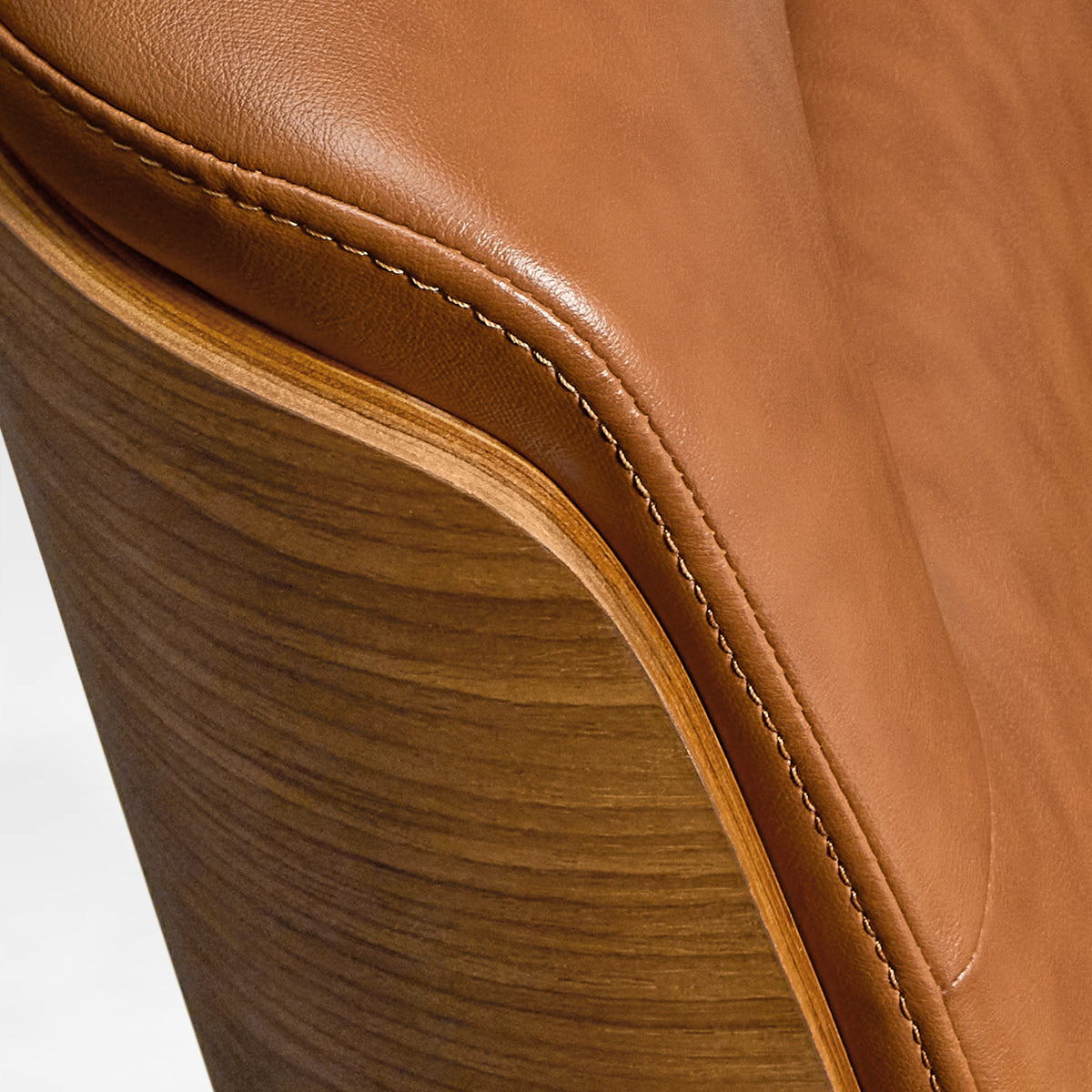 Eureka Ergonomic close-up of the brown Mathias Mason chair's walnut back and leather upholstery seam