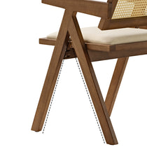 Eureka Ergonomic Mila walnut dining chair close-up: woven rattan back, cream seat, splayed legs. Highlights mid-century modern design.