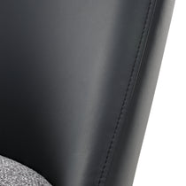 Close-Up of Black Leather Dining Chair Backrest, Showcasing Texture and Stitching Details. Part of Solace Dining Chair Set.